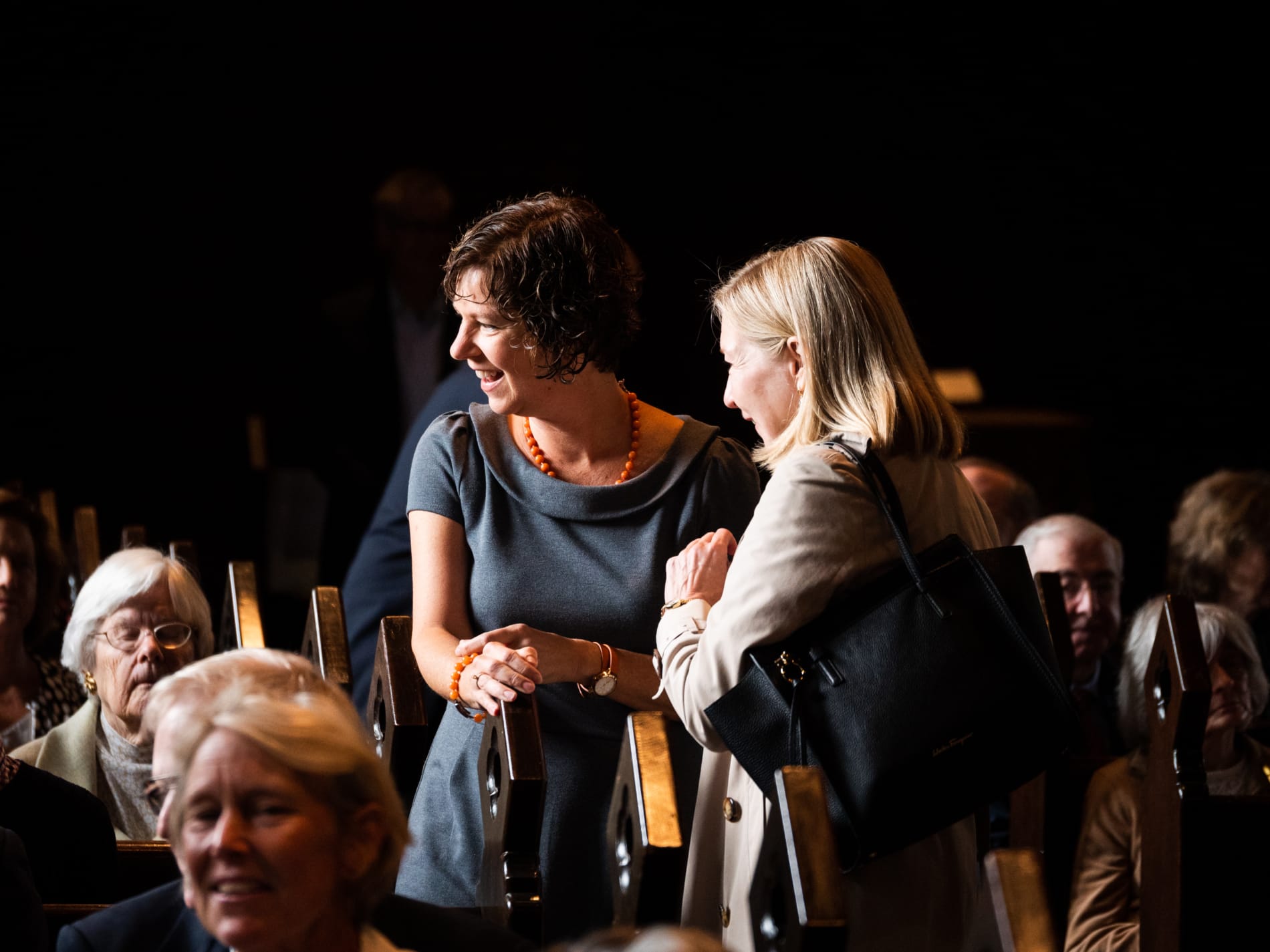 Two women chatting in church