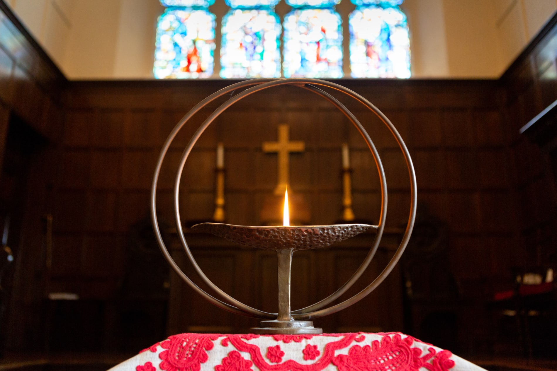 The Unitarian flaming chalice with a cross in the background