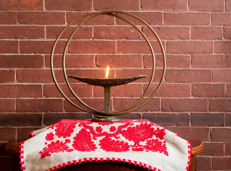 Our flaming chalice, on an altar cloth with traditional Hungarian embroidery.
