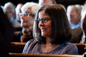 A woman listens to the minister preach